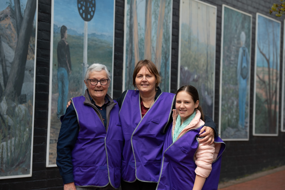 3 women from different generations smiling to camera