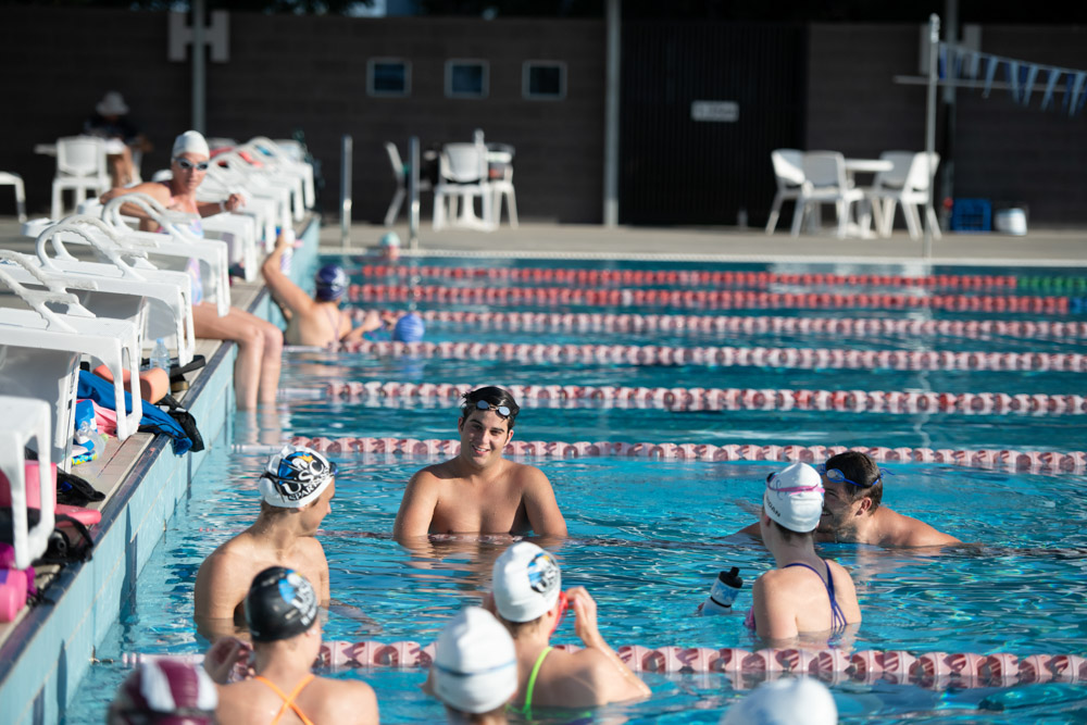 Group of swimmers chatting in pool