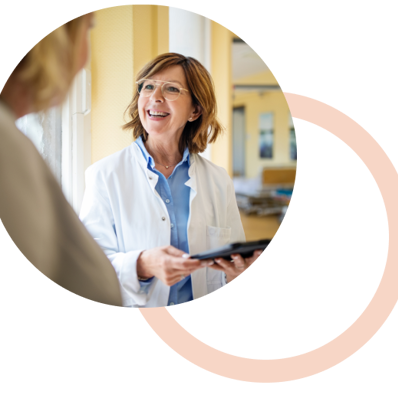 Doctor discussing with woman at hospital